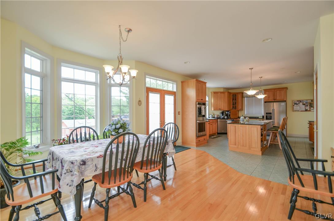 2359 Wehr Mill Road Allentown, PA 18104 - Photo 17 of 50 a dining room with furniture a chandelier and wooden floor