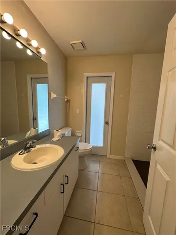 a bathroom with a granite countertop sink a mirror and a