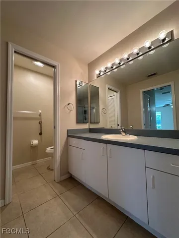 a spacious bathroom with a double vanity sink a mirror and a shower