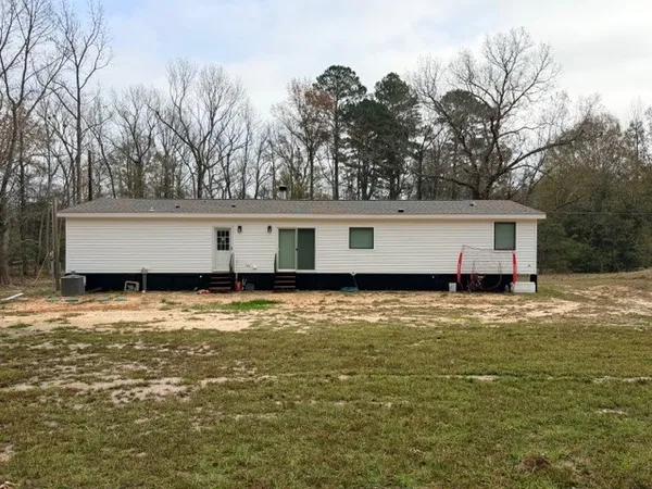 a view of house with pool and yard