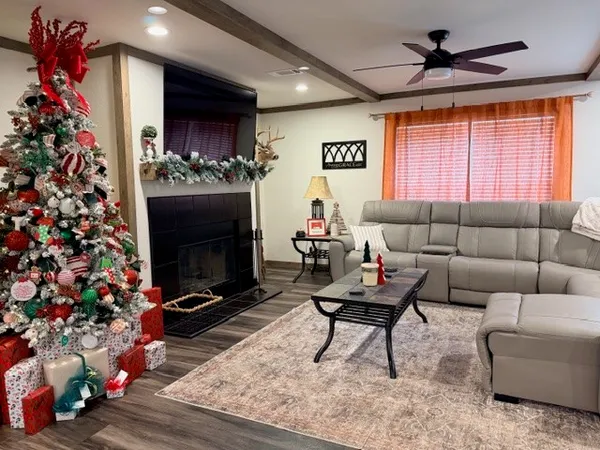 a living room with furniture a flat screen tv and a fireplace