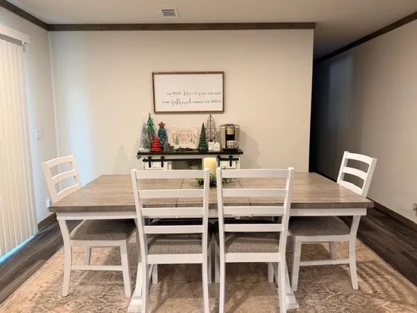 a dining room with furniture and window