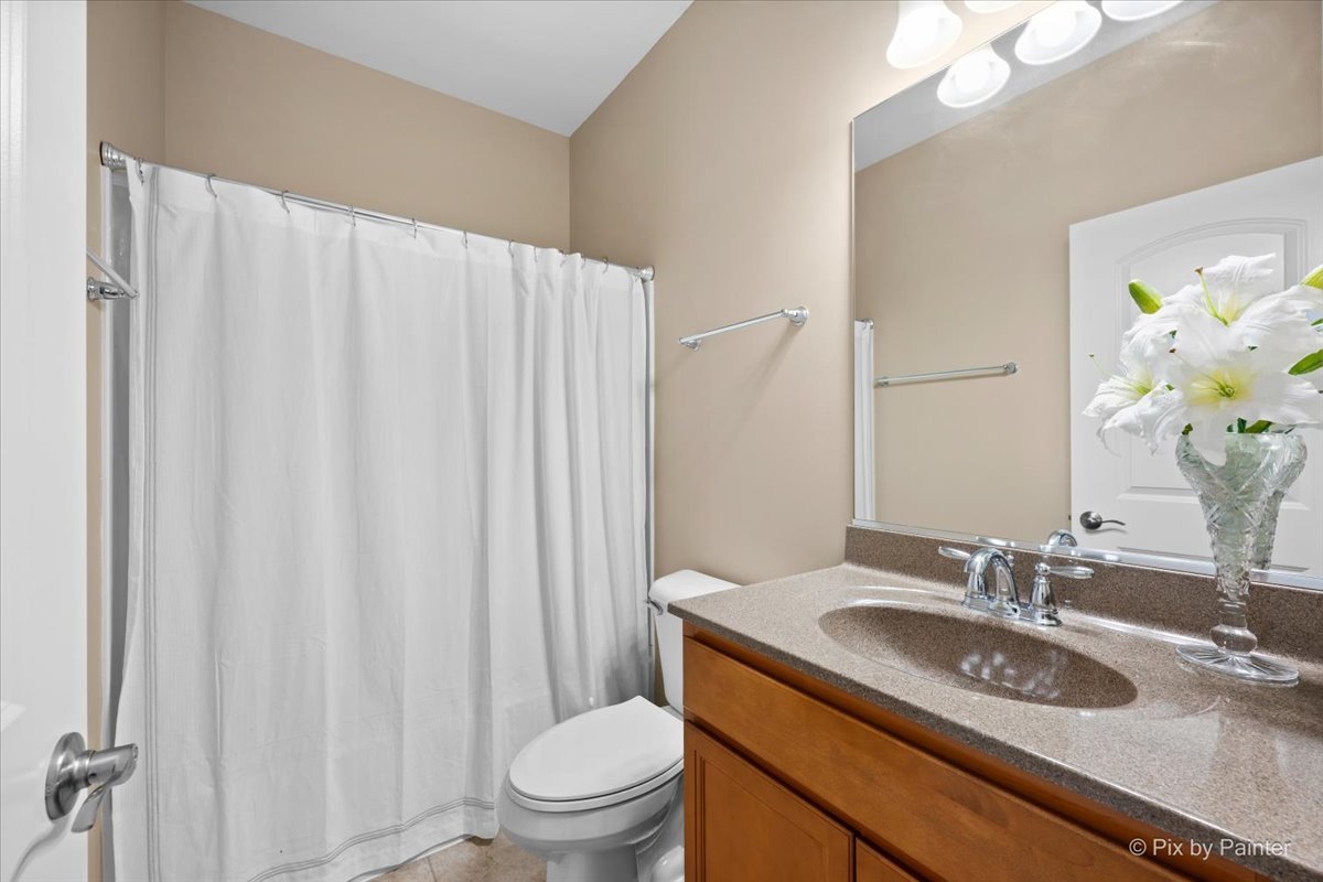 4375 Rudyard Kipling Road Elgin, IL 60124 - Photo 13 of 33 a bathroom with a granite countertop sink a toilet and a mirror
