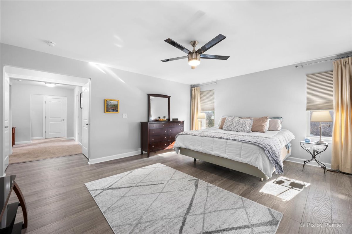 4375 Rudyard Kipling Road Elgin, IL 60124 - Photo 19 of 33 a bedroom with a bed and a chandelier