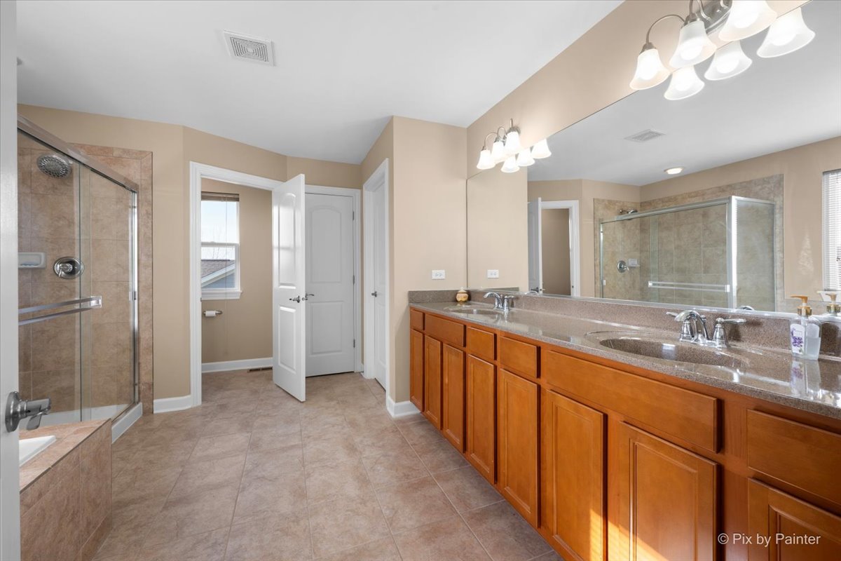 4375 Rudyard Kipling Road Elgin, IL 60124 - Photo 21 of 33 a large bathroom with a granite countertop sink mirror and a shower