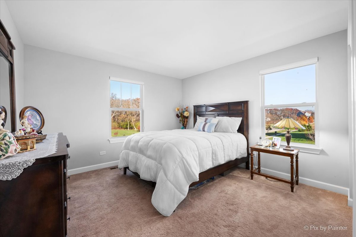 4375 Rudyard Kipling Road Elgin, IL 60124 - Photo 26 of 33 a bedroom with a bed chair and window