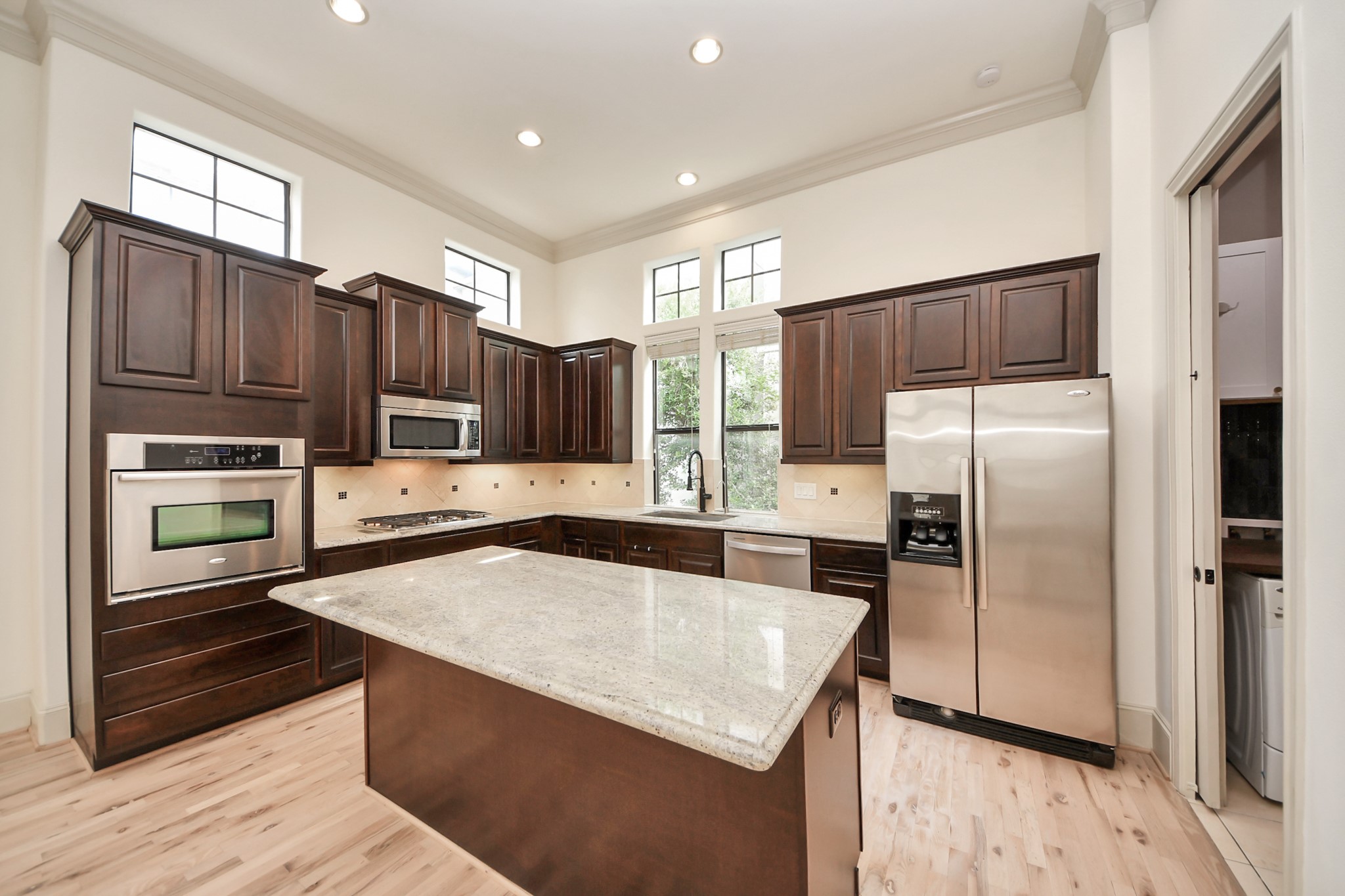 3229 Maxroy Street Houston, TX 77008 - Photo 2 of 43 bright, spacious kitchen featuring plenty of dark wood cabinets, stainless steel appliances, a huge center island, Gas cooktop and high ceilings with big windows that let in tons of natural light.
