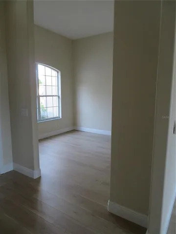 a front view of a house with a garden and palm trees