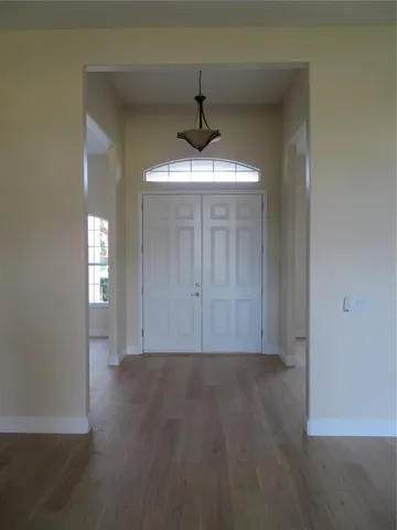 a front view of a house with a garden and trees