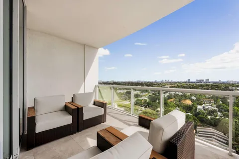 a balcony with furniture and view of lake