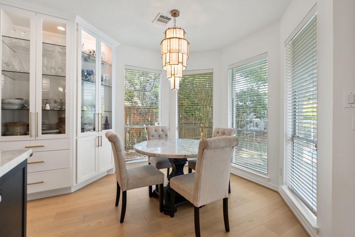 5515 Chase Harbor Houston, TX 77041 - Photo 13 of 48 Sunlit breakfast area wrapped in windows creates a bright, welcoming setting for casual meals, conversation, and morning coffee.