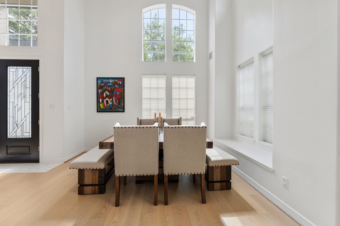 5515 Chase Harbor Houston, TX 77041 - Photo 19 of 48 Framed by soaring ceilings and beautiful natural light, the formal dining space feels airy, elegant, and ready for both intimate dinners and holiday gatherings.