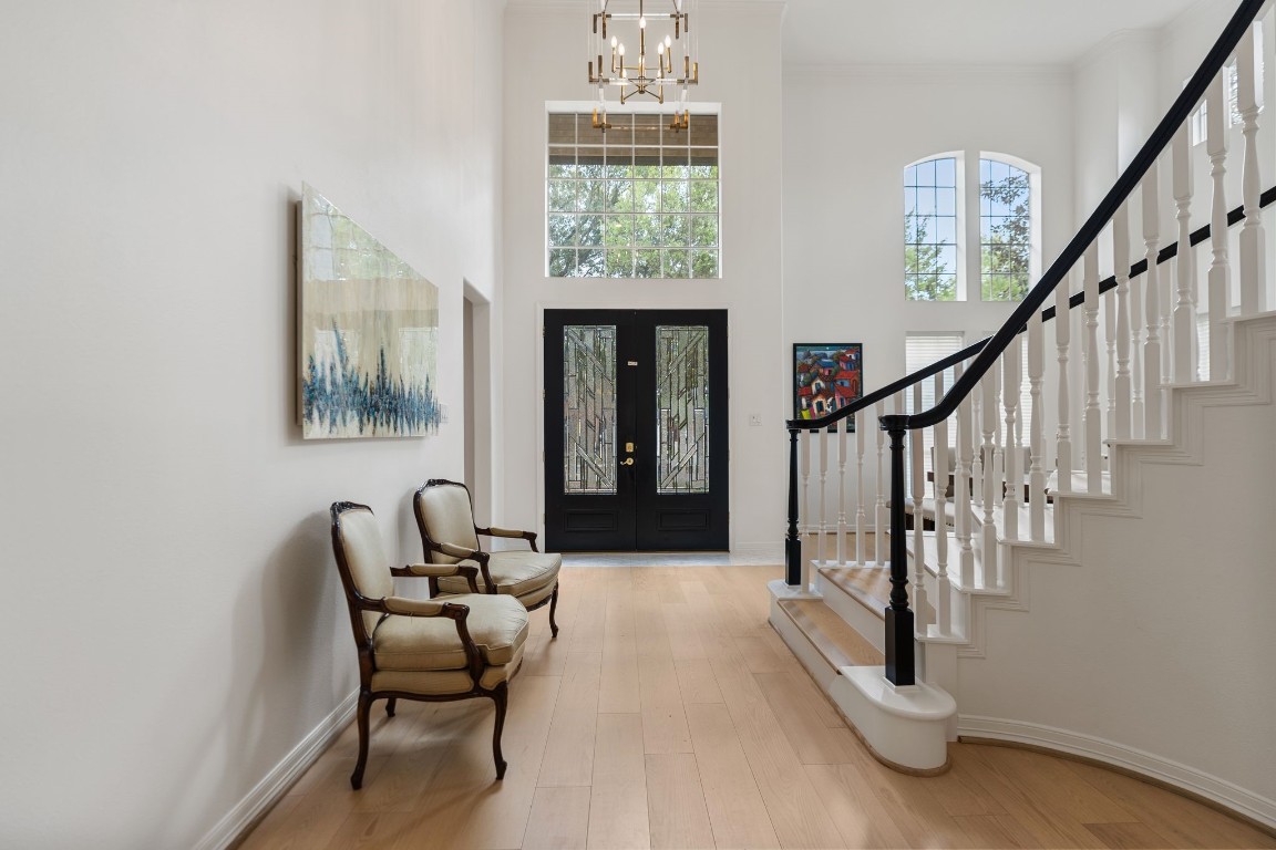5515 Chase Harbor Houston, TX 77041 - Photo 21 of 48 A sweeping staircase makes an immediate impression, blending warm wood treads with crisp white balusters. The light-filled foyer sets a refined yet welcoming tone the moment you step inside.