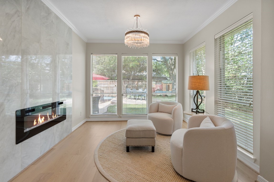 5515 Chase Harbor Houston, TX 77041 - Photo 22 of 48 A private retreat within the retreat. The primary sitting area features its own fireplace — the perfect space for morning coffee, evening unwinding, or a quiet escape from the day. Warm, intimate, and thoughtfully designed for comfort.
