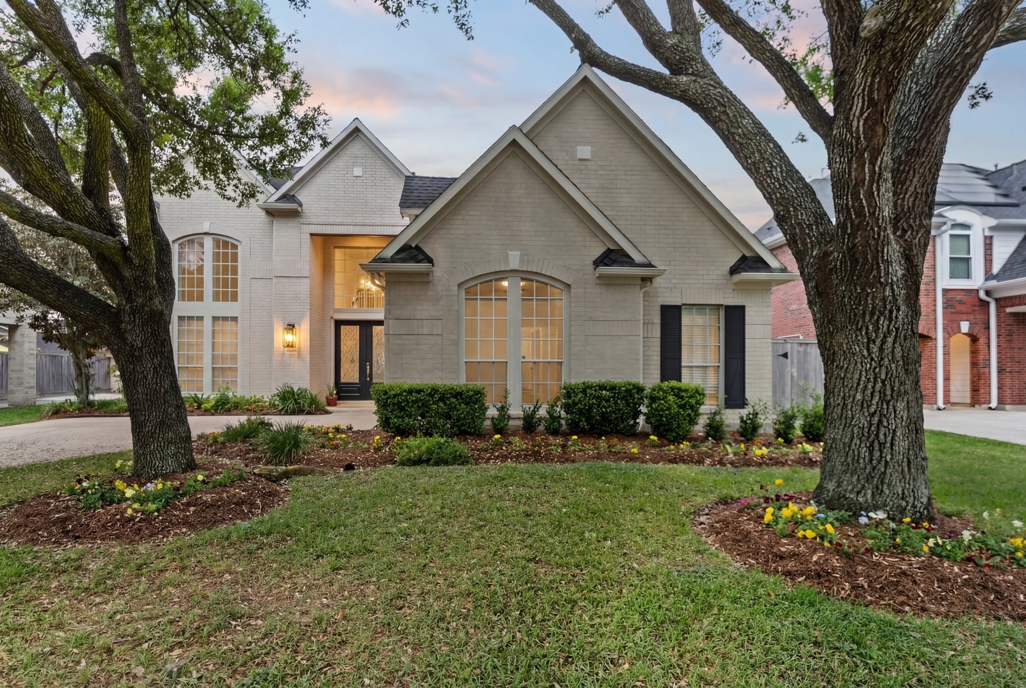 5515 Chase Harbor Houston, TX 77041 - Photo 3 of 48 Classic brick elegance meets manicured landscaping in this stately two-story home tucked inside a 24-hour guard-gated community. Mature trees frame the façade while the wide driveway and clean lines create timeless curb appeal.