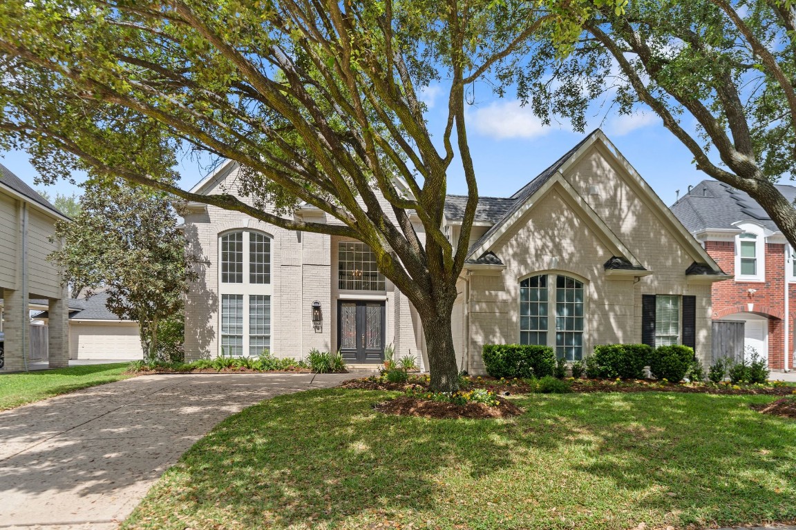5515 Chase Harbor Houston, TX 77041 - Photo 38 of 48 Classic brick elegance meets manicured landscaping in this stately two-story home tucked inside a 24-hour guard-gated community. Mature trees frame the façade while the wide driveway and clean lines create timeless curb appeal.