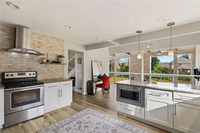 a kitchen with stainless steel appliances granite countertop a stove and a sink