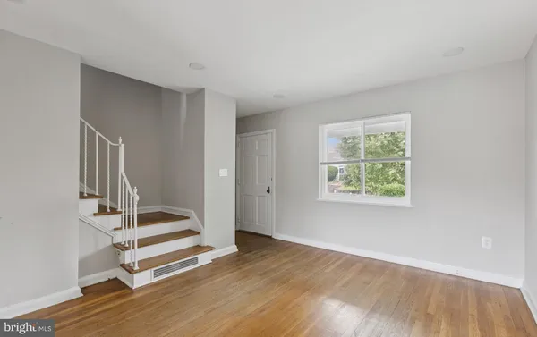 a view of wooden floor and windows in a room