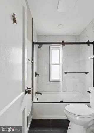 a bathroom with a toilet and a bathtub