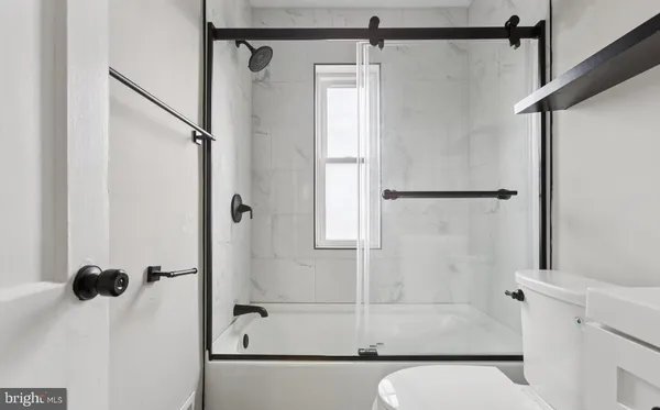 a bathroom with a shower and a tub