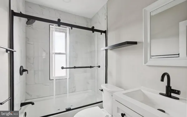 a bathroom with a shower and a sink