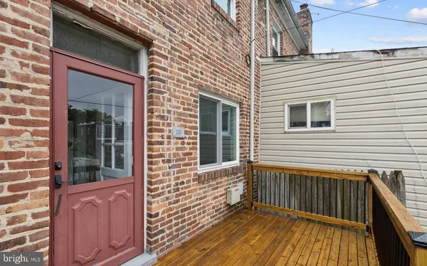 a view of a porch with wooden floor and fence
