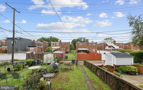 a view of a house with a chairs and table in a patio