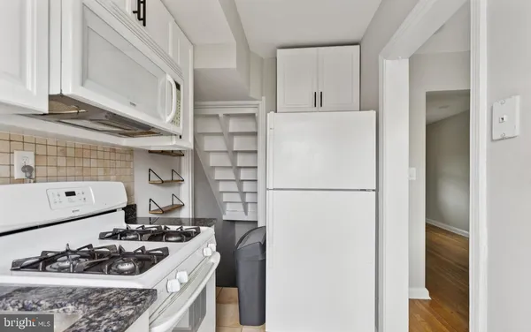 a kitchen with a refrigerator and a stove