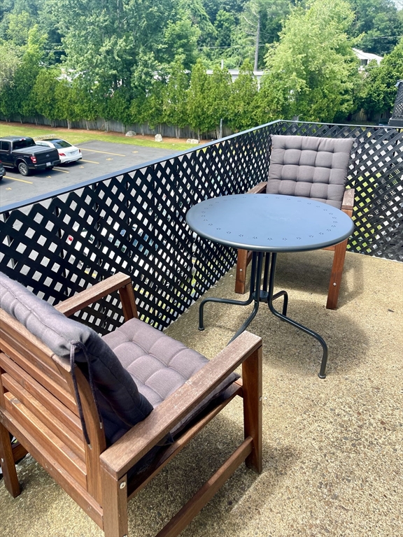 176 Maple Avenue, Unit 133 Rutland, MA 01543 - Photo 13 of 14 a view of a roof deck with table and chairs