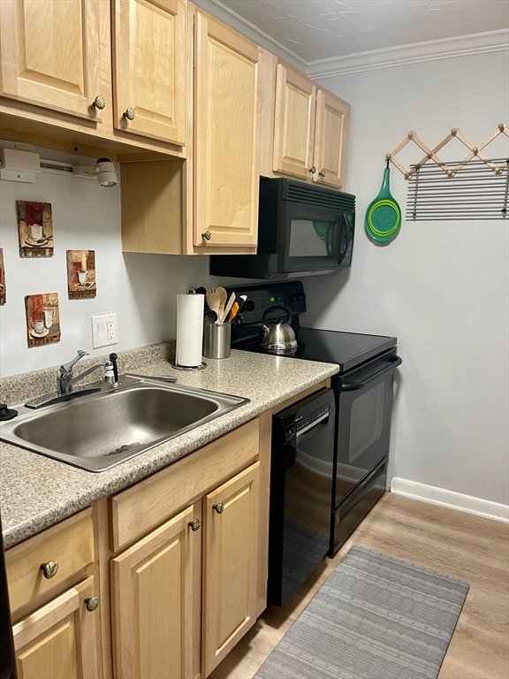 176 Maple Avenue, Unit 133 Rutland, MA 01543 - Photo 2 of 14 a kitchen with stainless steel appliances granite countertop a sink a stove a microwave a counter space and cabinets
