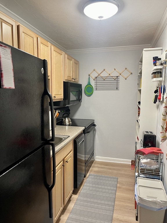 176 Maple Avenue, Unit 133 Rutland, MA 01543 - Photo 3 of 14 a kitchen with a refrigerator and a sink