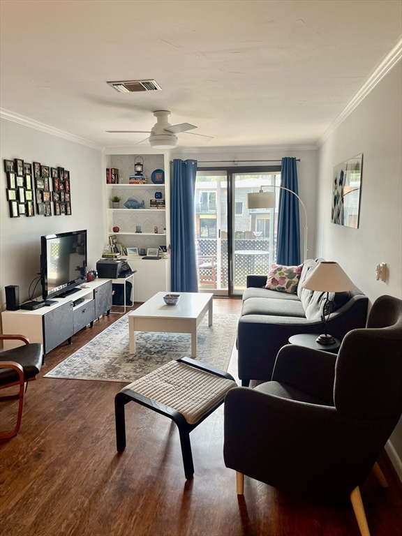 176 Maple Avenue, Unit 133 Rutland, MA 01543 - Photo 7 of 14 a living room with furniture wooden floor and a large window