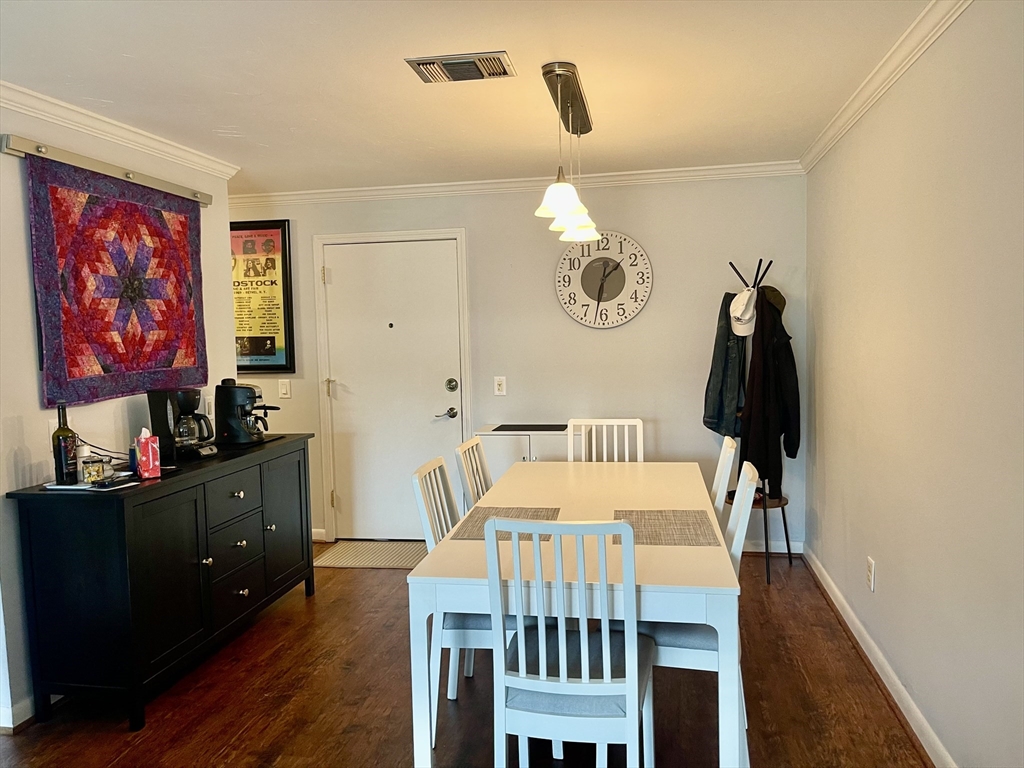 176 Maple Avenue, Unit 133 Rutland, MA 01543 - Photo 8 of 14 a view of a dining room with furniture and wooden floor