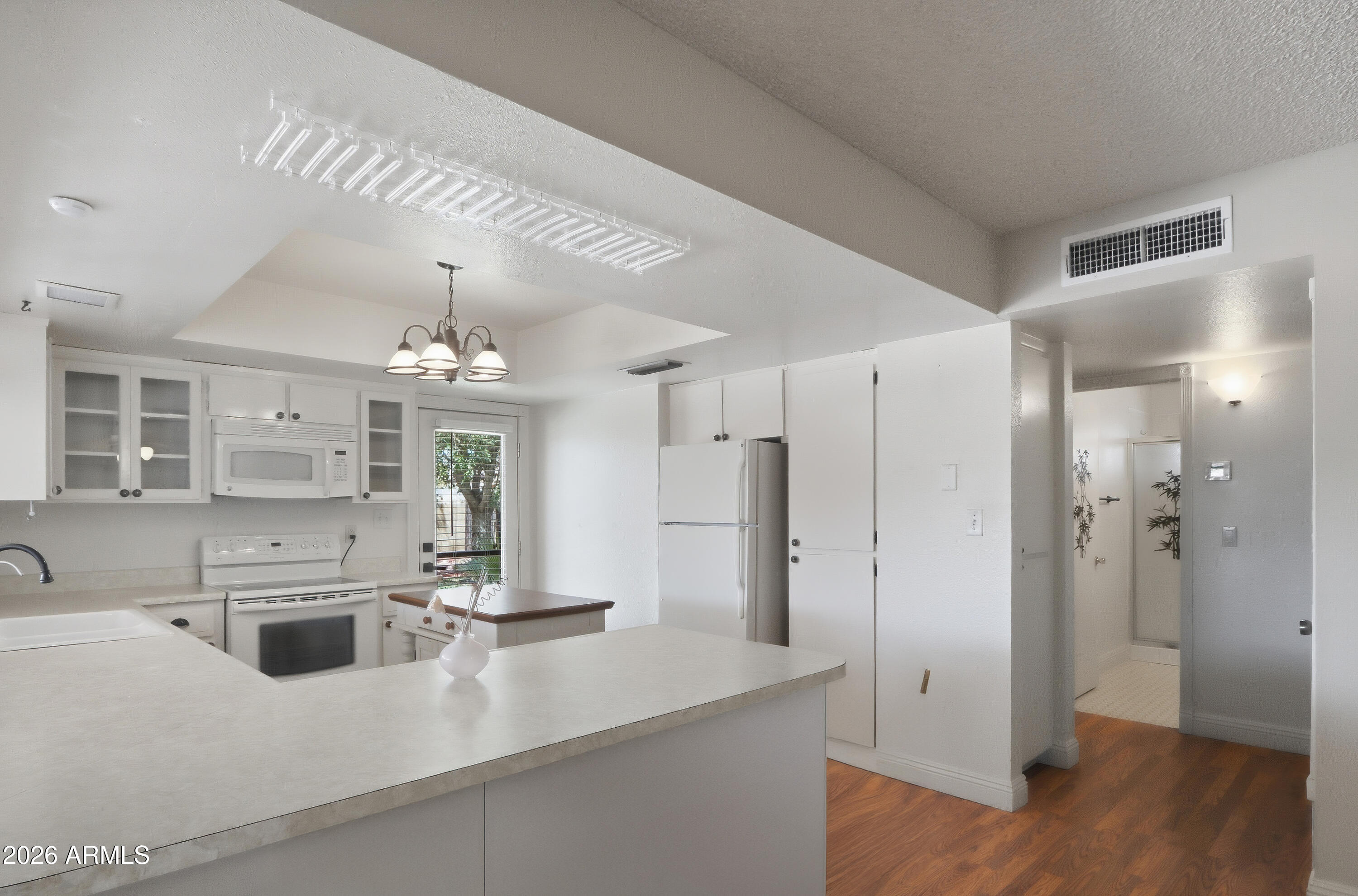 450 Cascada Road Litchfield Park, AZ 85340 - Photo 15 of 40 a kitchen with stainless steel appliances a sink stove and refrigerator