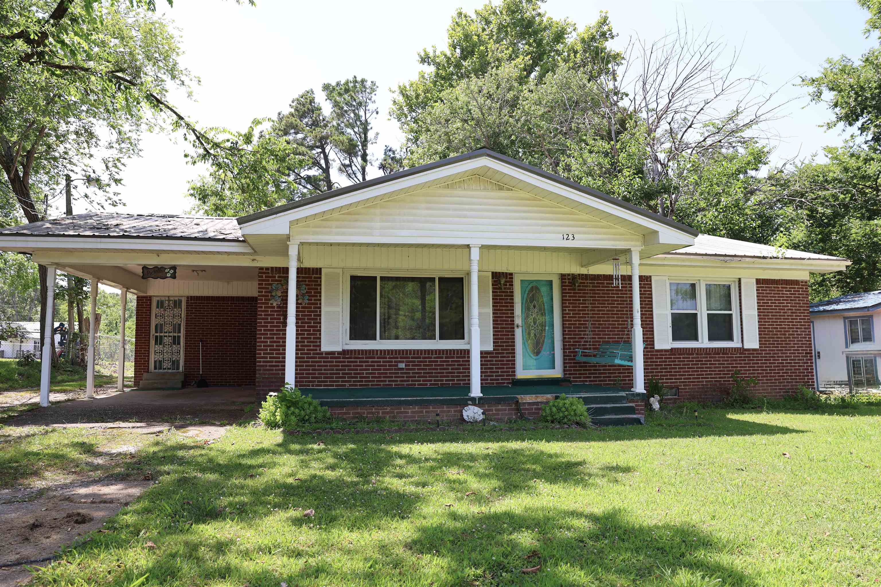 123 North Magnolia Street Adamsville, TN 38310 - Photo 4 of 25 a front view of a house with a yard