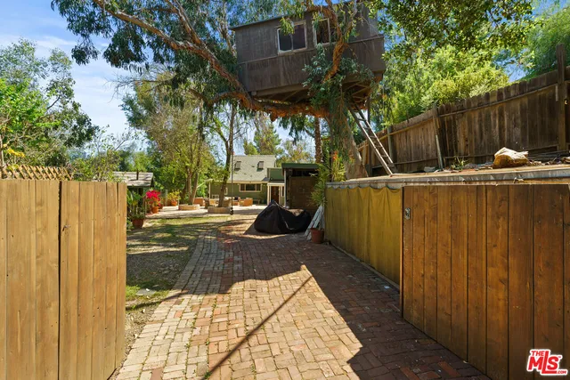 a view of a backyard with sitting area