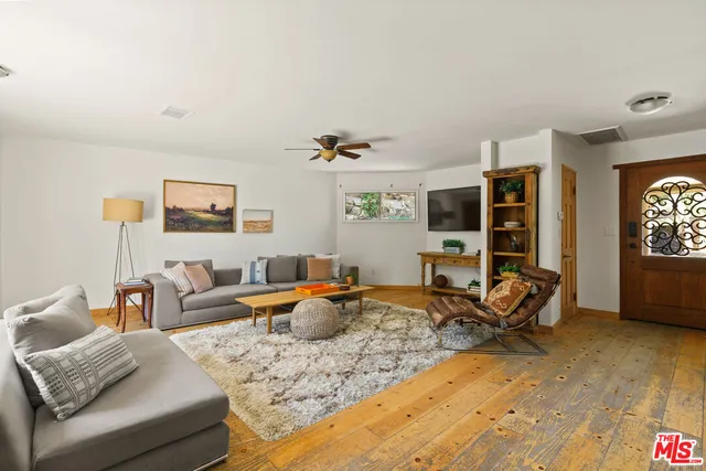 a living room with furniture window and flat screen tv