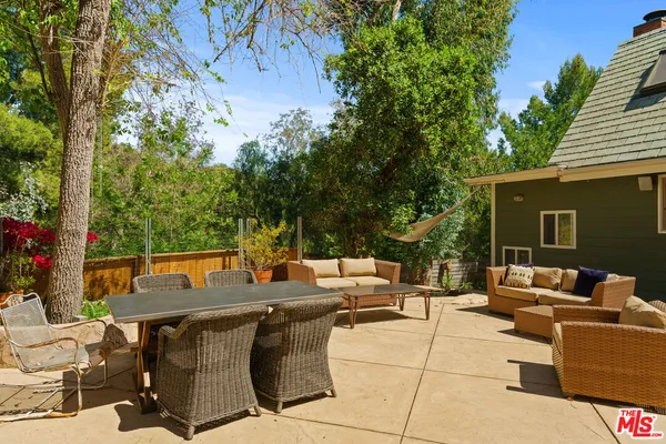 outdoor seating area with furniture and potted plants
