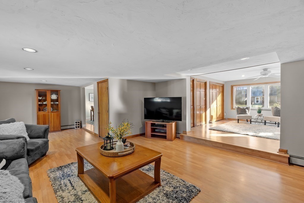 67 Pine Street Sudbury, MA 01776 - Photo 11 of 41 a living room with furniture a flat screen tv and a large window