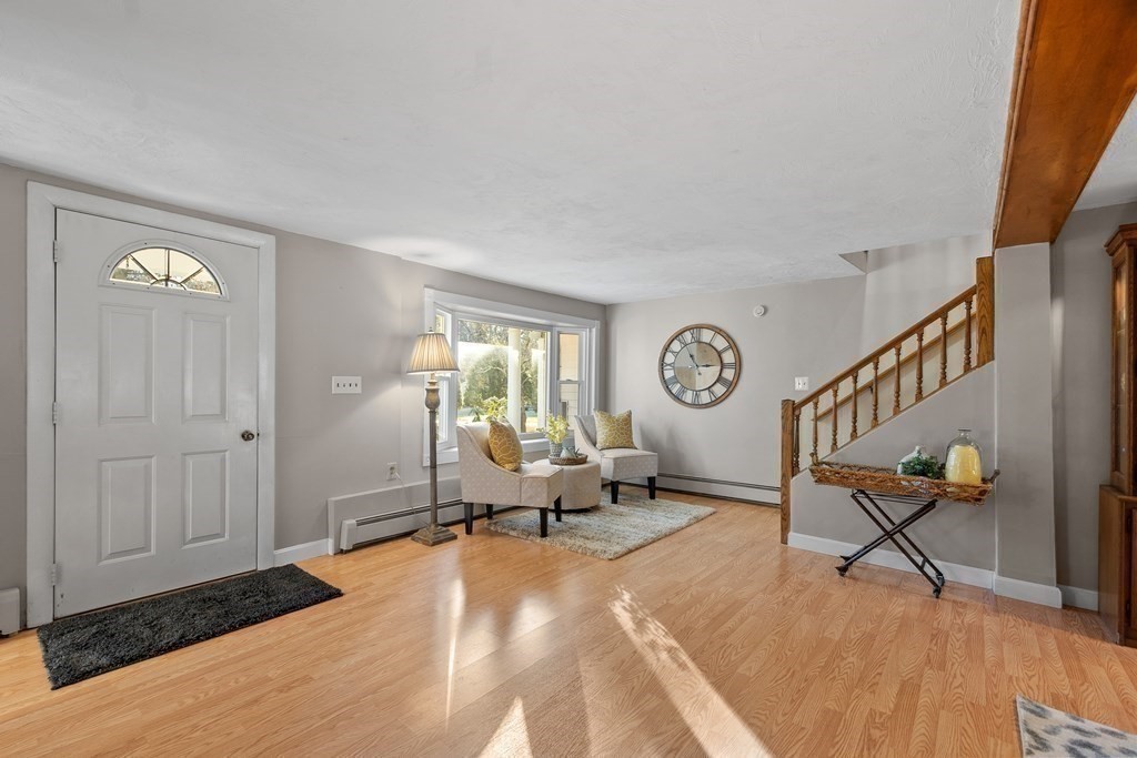 67 Pine Street Sudbury, MA 01776 - Photo 15 of 41 a living room with furniture a clock and a window