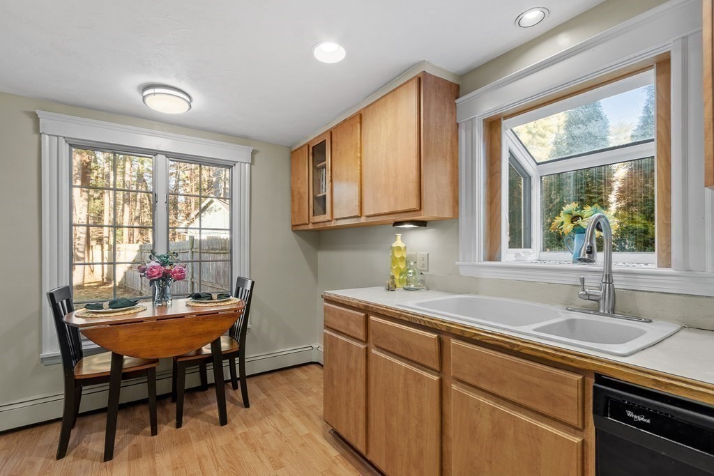 67 Pine Street Sudbury, MA 01776 - Photo 18 of 41 a kitchen with a sink a window and chairs