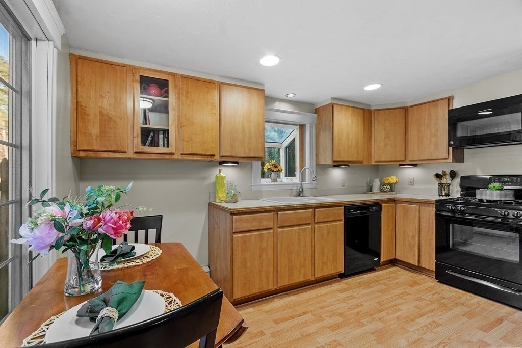 67 Pine Street Sudbury, MA 01776 - Photo 19 of 41 a kitchen with stainless steel appliances granite countertop a sink stove and cabinets