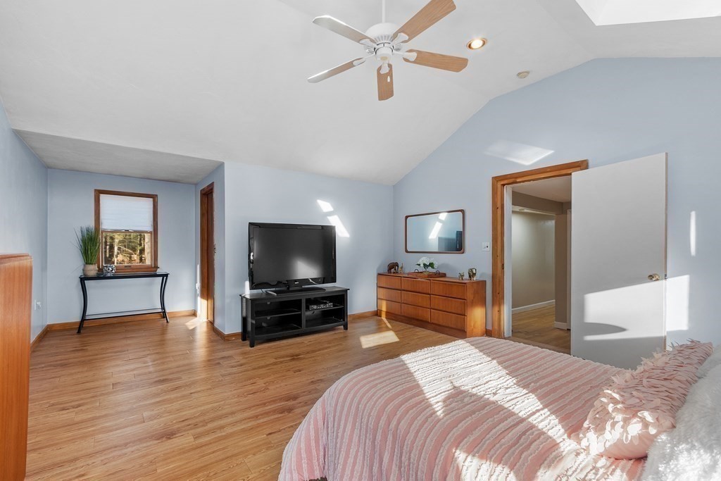 67 Pine Street Sudbury, MA 01776 - Photo 23 of 41 a bedroom with a bed and a flat screen tv