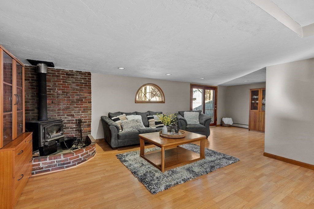 67 Pine Street Sudbury, MA 01776 - Photo 10 of 41 a living room with fireplace furniture and a rug