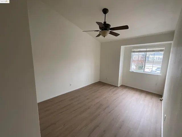 a view of room with hardwood floor and window