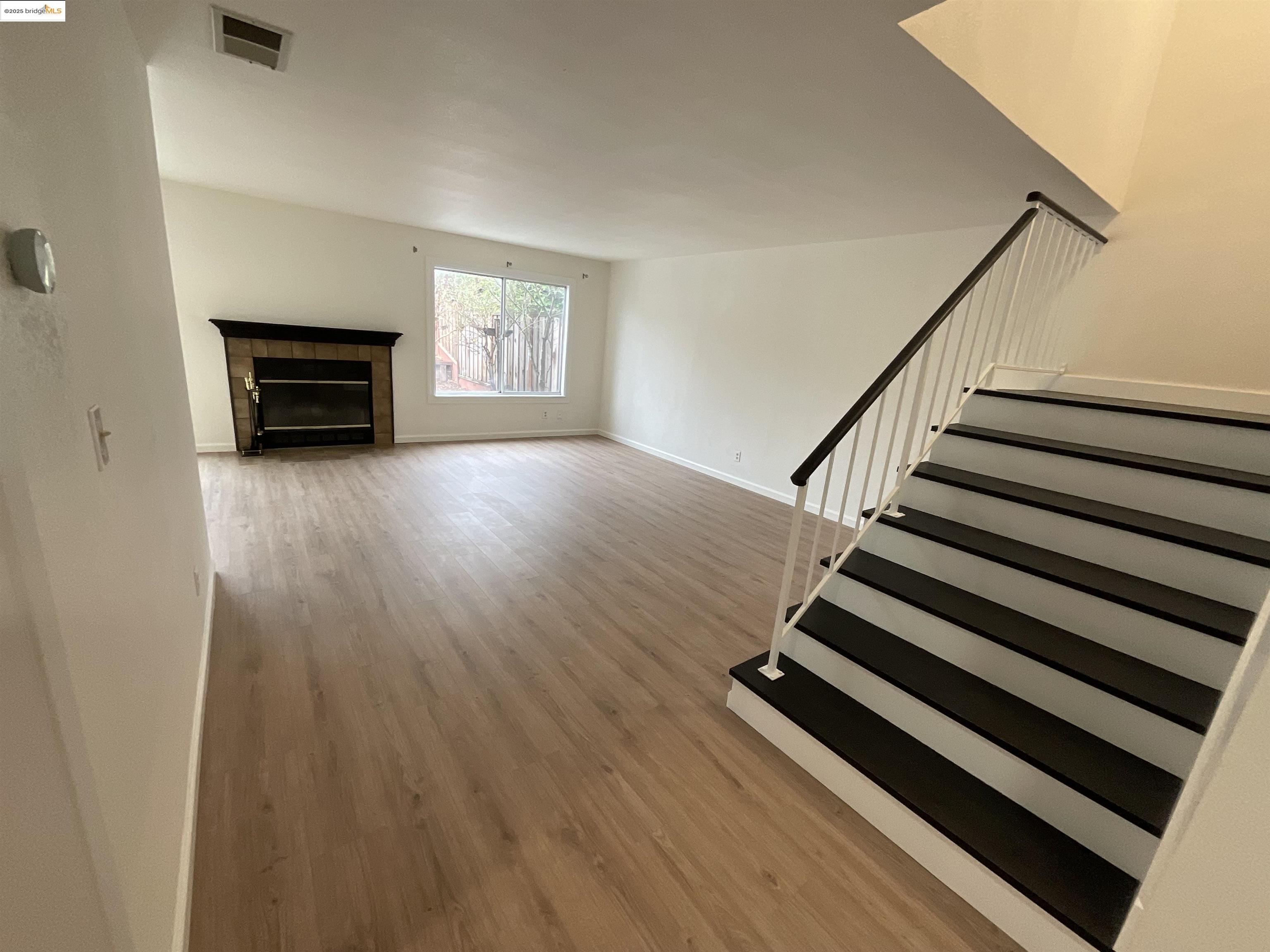 131 Pelican Loop Pittsburg, CA 94565 - Photo 3 of 16 a view of a livingroom with wooden floor and a ceiling fan