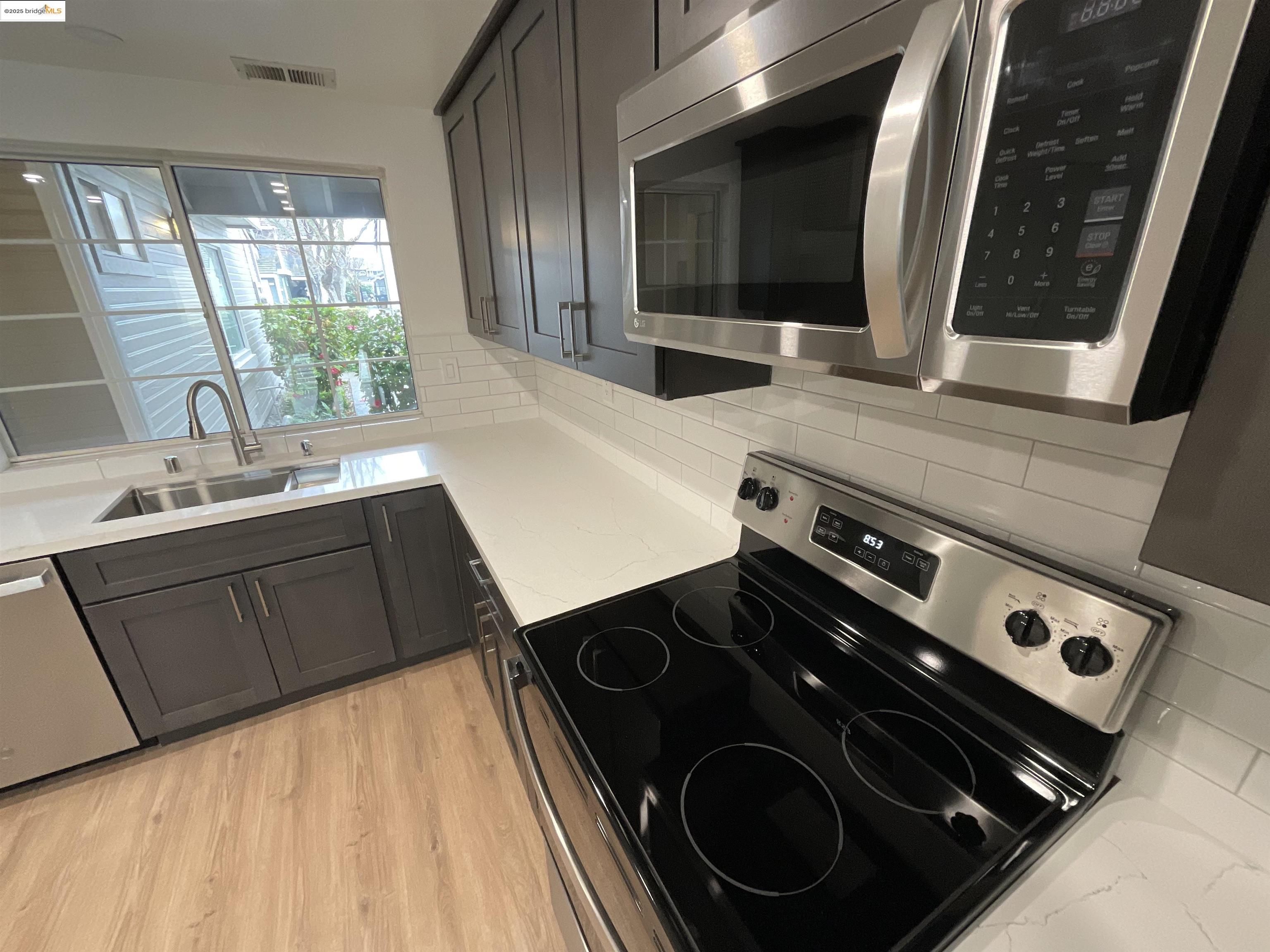 131 Pelican Loop Pittsburg, CA 94565 - Photo 6 of 16 a kitchen with a stove and a sink