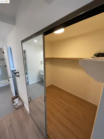 a view of a room with wooden floor and windows