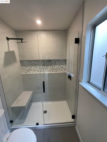 a bathroom with a shower and toilet