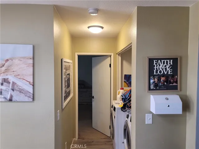 a view of a hallway to rooms and stairs
